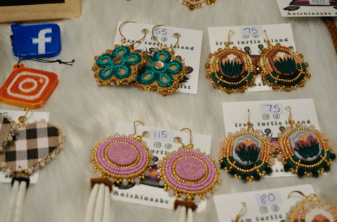 Close up on a display of beaded earrings for sale.